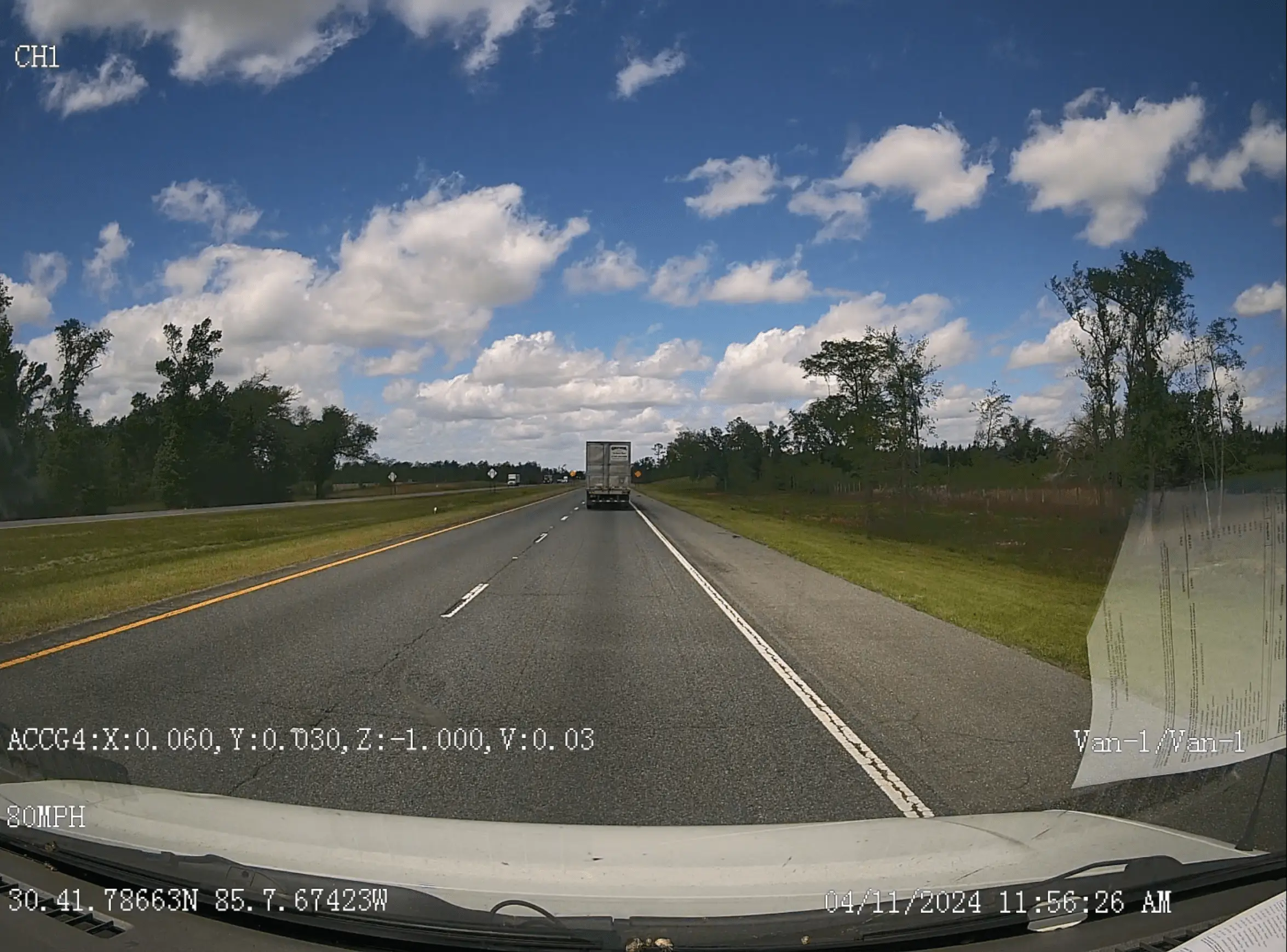 Exterior road-facing VX4AI camera view through a vehicle windshield.